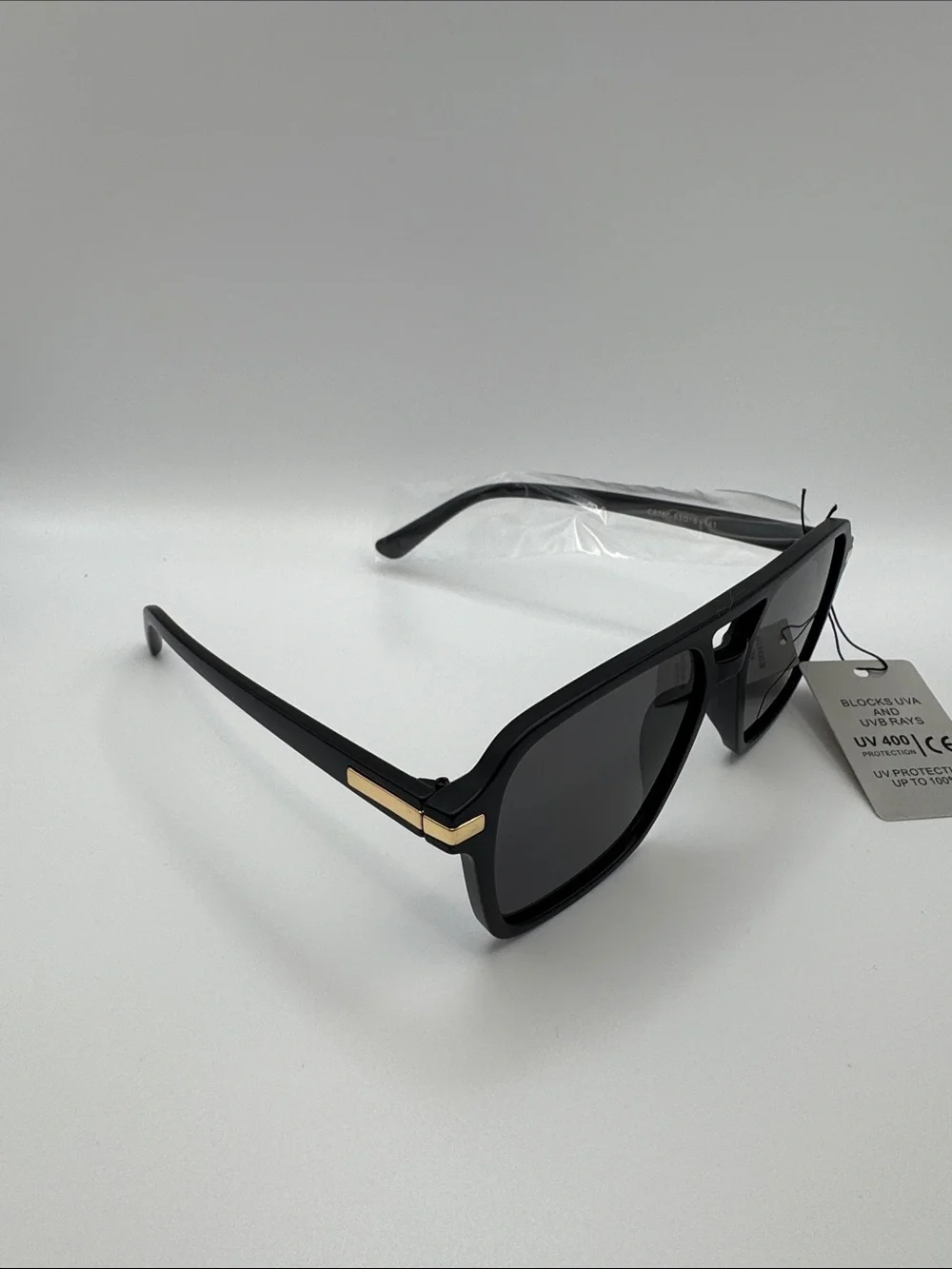 Black Sunglasses with Dark Lenses and Gold Accents